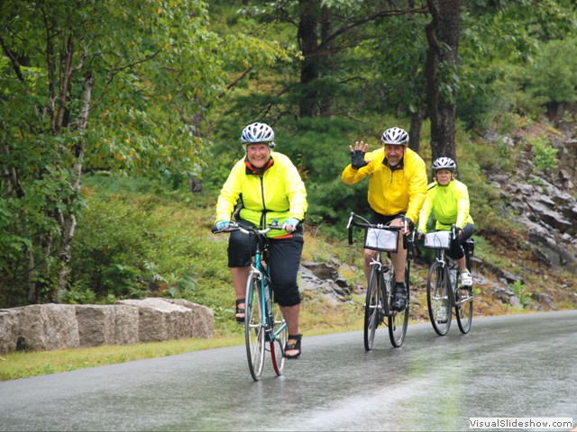 July 29: Nancy biking in the rain with Tony and Pam.  There were 19 total guests on this trip along with the 3 leaders.  The two 11-passenger vans were a perfect fit.