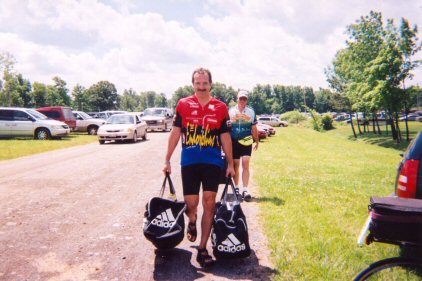 Pete and Bob carrying bags to Bob's truck